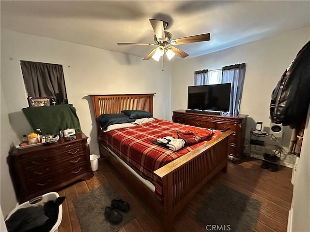 bedroom with ceiling fan and dark wood-type flooring