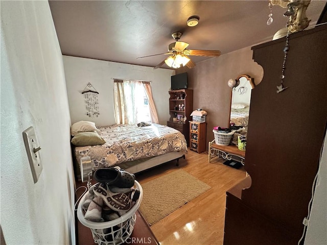 bedroom featuring ceiling fan and wood-type flooring