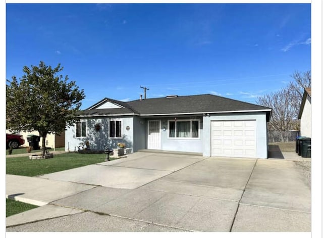 single story home featuring a garage and a front yard