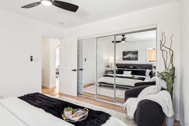 bedroom featuring a closet, ceiling fan, and light hardwood / wood-style flooring