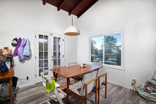 dining space with hardwood / wood-style floors, french doors, high vaulted ceiling, wooden ceiling, and beam ceiling