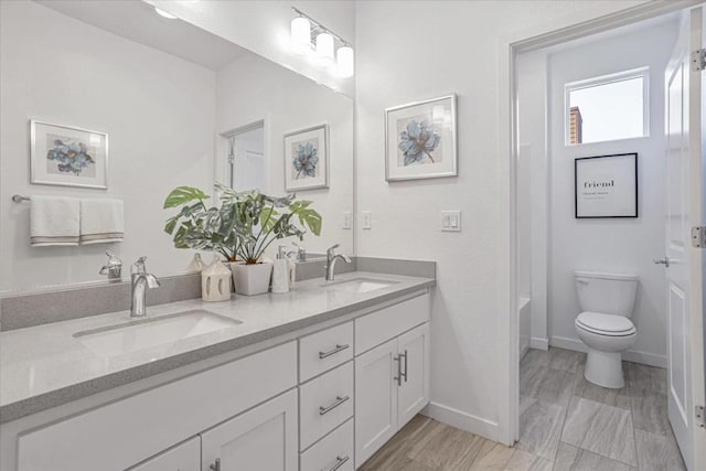 bathroom with toilet and vanity