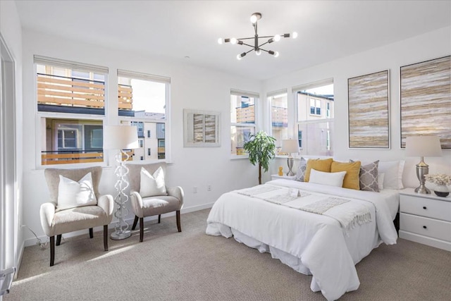 carpeted bedroom with an inviting chandelier