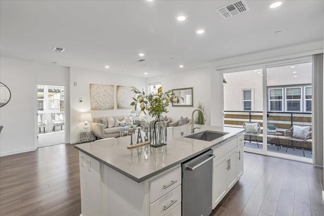 kitchen featuring white cabinets, dark hardwood / wood-style flooring, sink, a kitchen island with sink, and stainless steel dishwasher