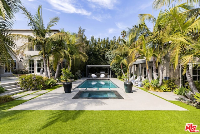 view of swimming pool featuring an in ground hot tub, a patio area, and a yard