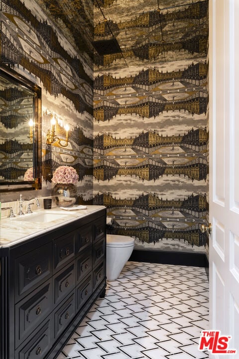 bathroom featuring toilet and vanity