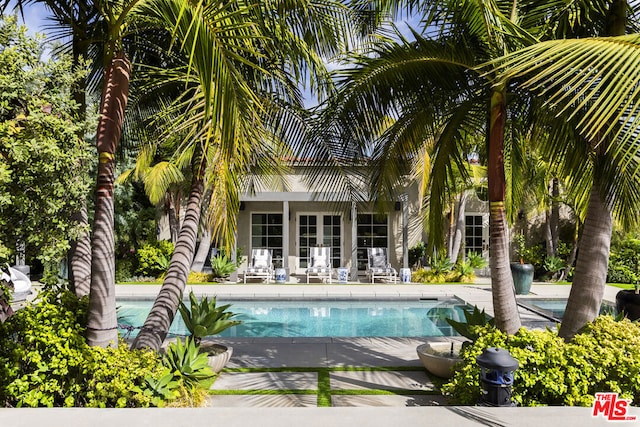 view of pool with a patio area and an outbuilding