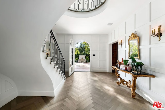 entryway featuring parquet flooring