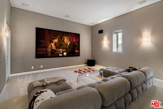 cinema room featuring light carpet