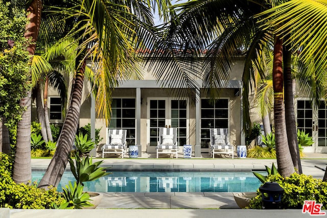 rear view of property with french doors and a patio