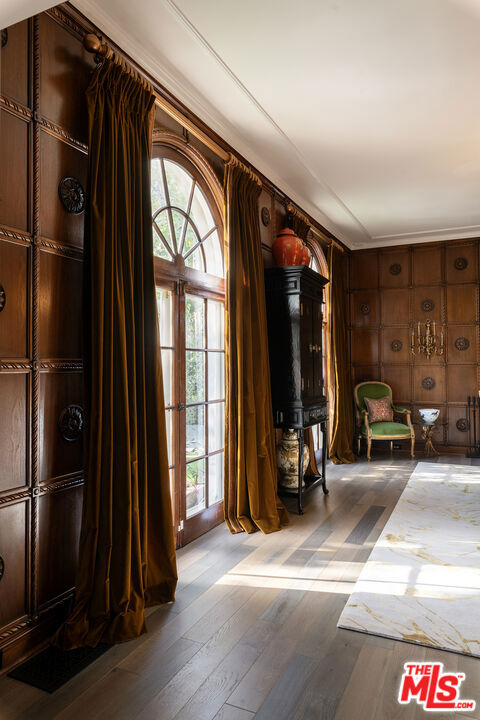 interior space featuring light hardwood / wood-style floors and wood walls