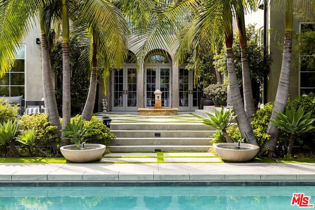 view of pool featuring french doors