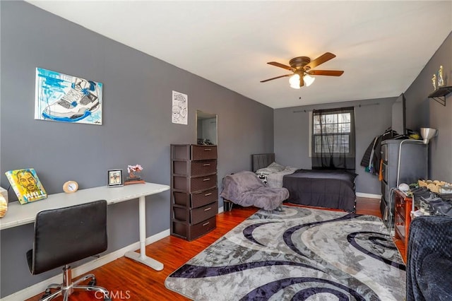 bedroom featuring ceiling fan and dark wood-type flooring