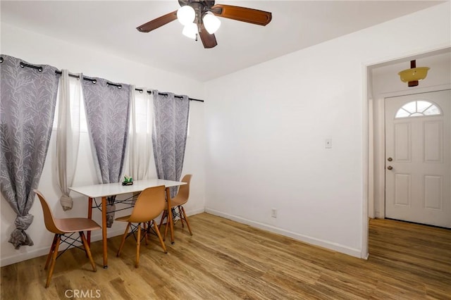 dining space with ceiling fan, hardwood / wood-style flooring, and a wealth of natural light