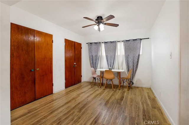 living area featuring hardwood / wood-style floors and ceiling fan