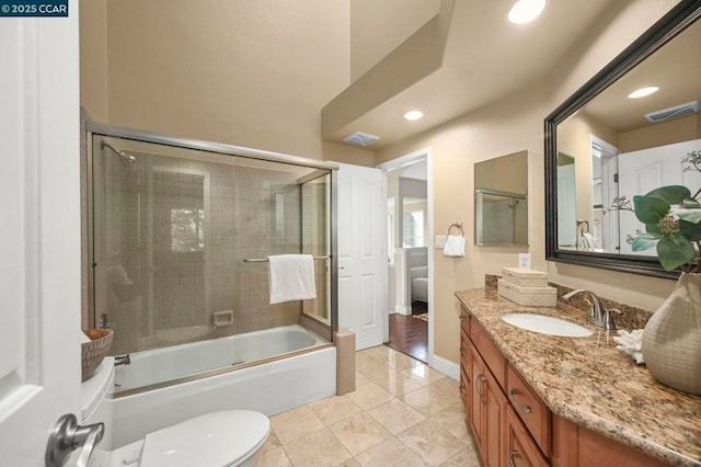 full bathroom with vanity, toilet, enclosed tub / shower combo, and tile patterned floors