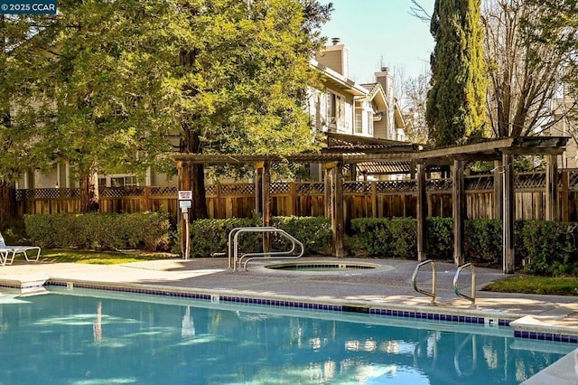 view of swimming pool with a community hot tub and a pergola