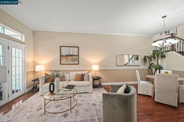 living room with a notable chandelier, ornamental molding, and dark wood-type flooring