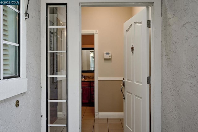 corridor featuring light tile patterned flooring