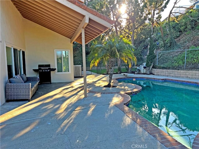 view of pool with outdoor lounge area, area for grilling, and a patio area