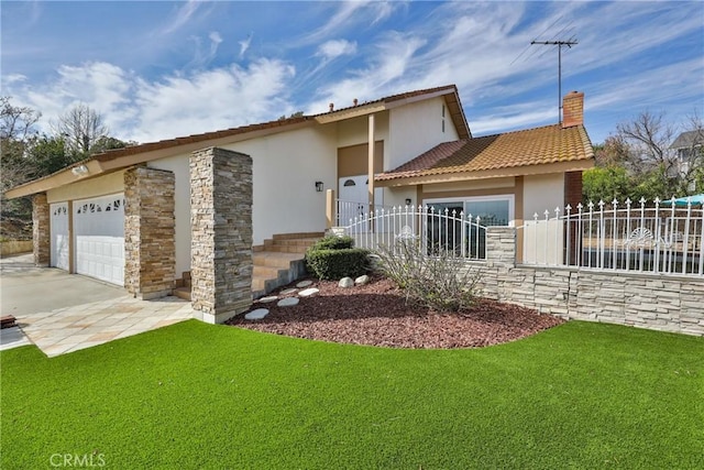 view of front of property with a garage and a front yard