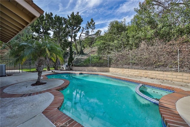 view of swimming pool with central AC and a patio