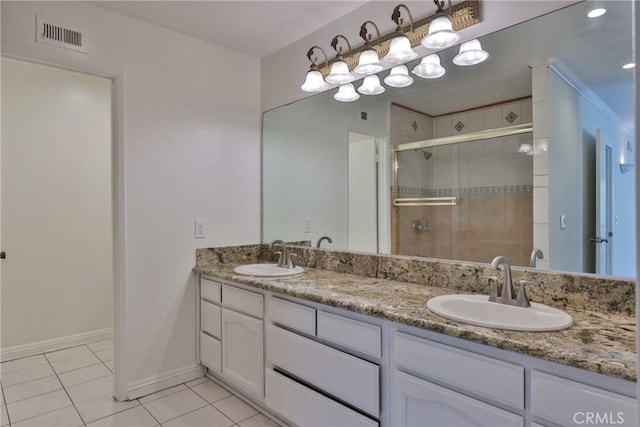 bathroom with tile patterned flooring, vanity, and an enclosed shower