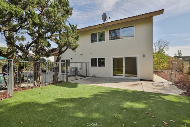 back of property featuring a patio and a yard