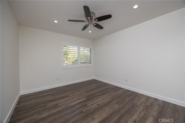 spare room with ceiling fan and dark hardwood / wood-style floors