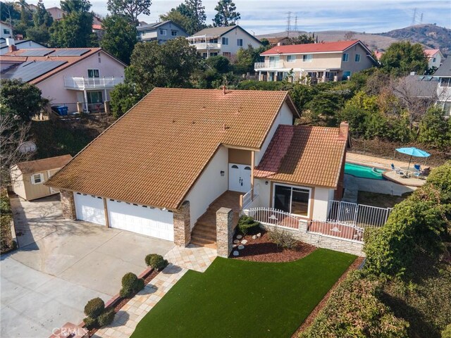 3179 Canal Point Dr, Hacienda Heights, CA 91745 - view of front of house with a tiled roof, a residential view, stucco siding, a garage, and a chimney
