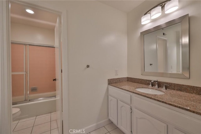 full bathroom featuring tile patterned flooring, vanity, toilet, and combined bath / shower with glass door