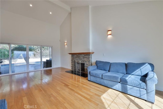 living room with beam ceiling, high vaulted ceiling, and light wood-type flooring