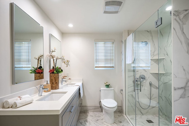 bathroom with vanity, a shower with shower door, and toilet