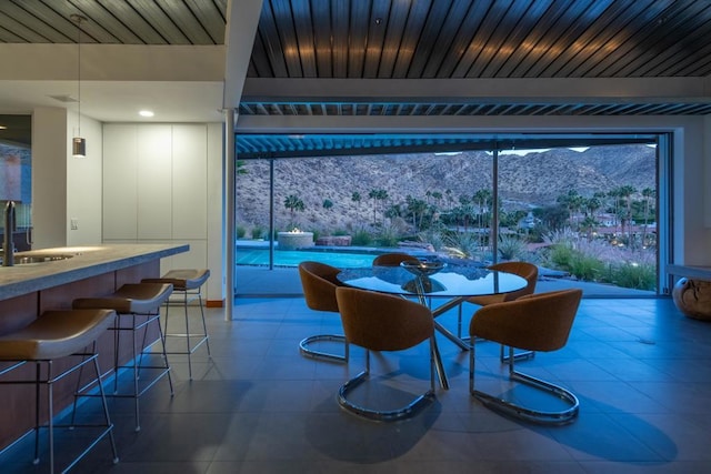 dining area with a mountain view and sink