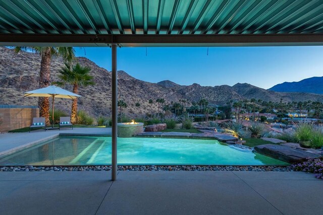 view of pool with a mountain view and a patio area