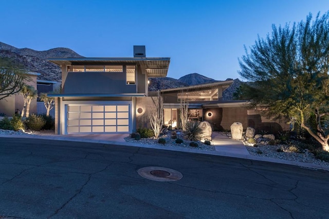 view of front of property featuring a garage and a mountain view