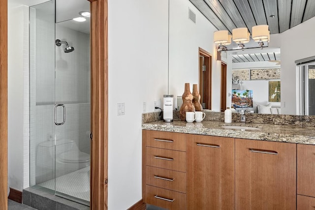 bathroom with walk in shower and vanity