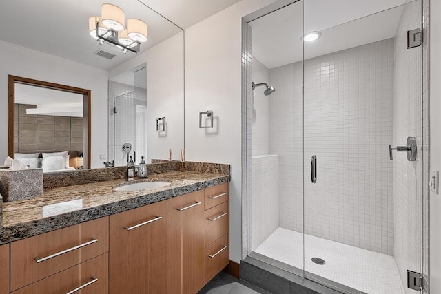 bathroom with vanity and a shower with shower door