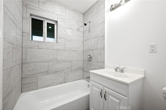 full bathroom featuring vanity, toilet, and tiled shower / bath