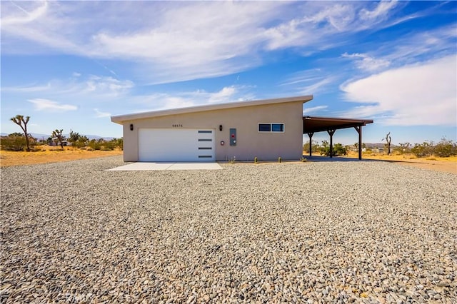 view of front of property with a garage and a carport