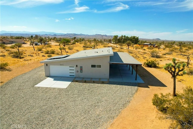 view of front of property with a garage and a mountain view