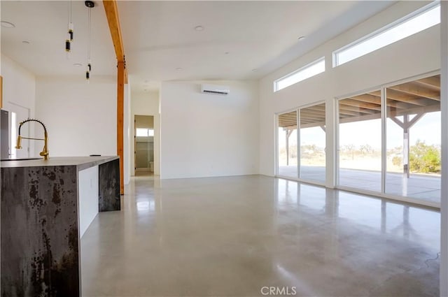 unfurnished room with sink and a wall unit AC