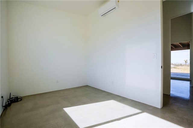 spare room featuring concrete floors and a wall unit AC