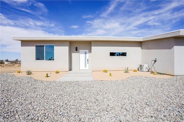 view of front of house featuring a patio area and ac unit