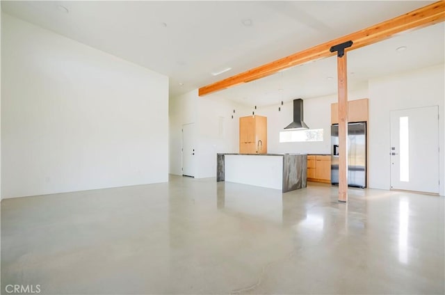 unfurnished living room with sink and beam ceiling