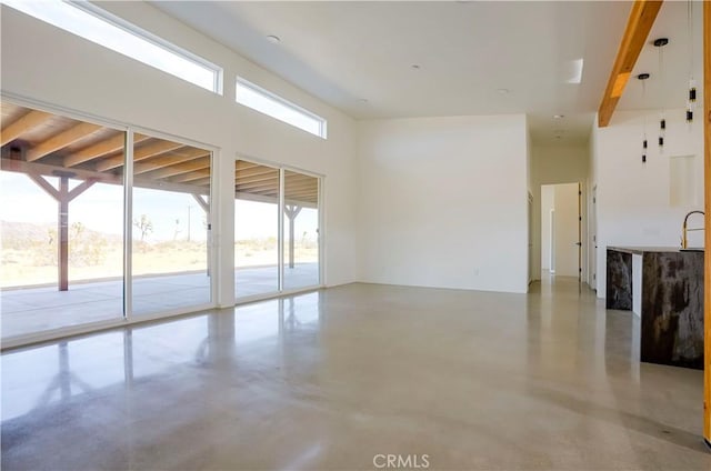 interior space featuring sink and beam ceiling