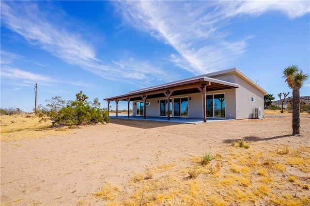 rear view of house featuring a patio area and central AC unit