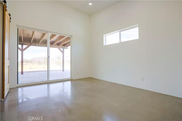 unfurnished room with a barn door