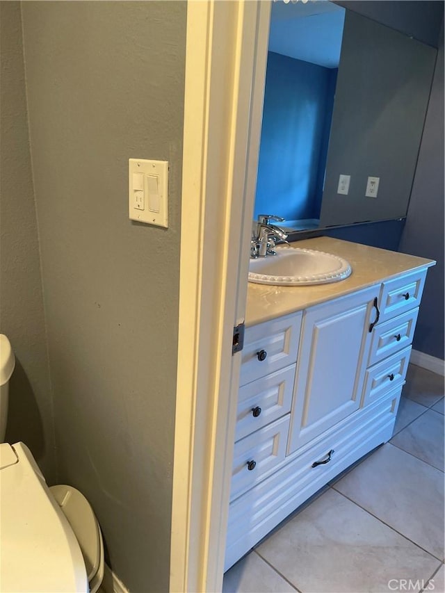 bathroom featuring vanity, toilet, and tile patterned flooring