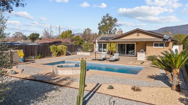 view of swimming pool with an in ground hot tub and a patio